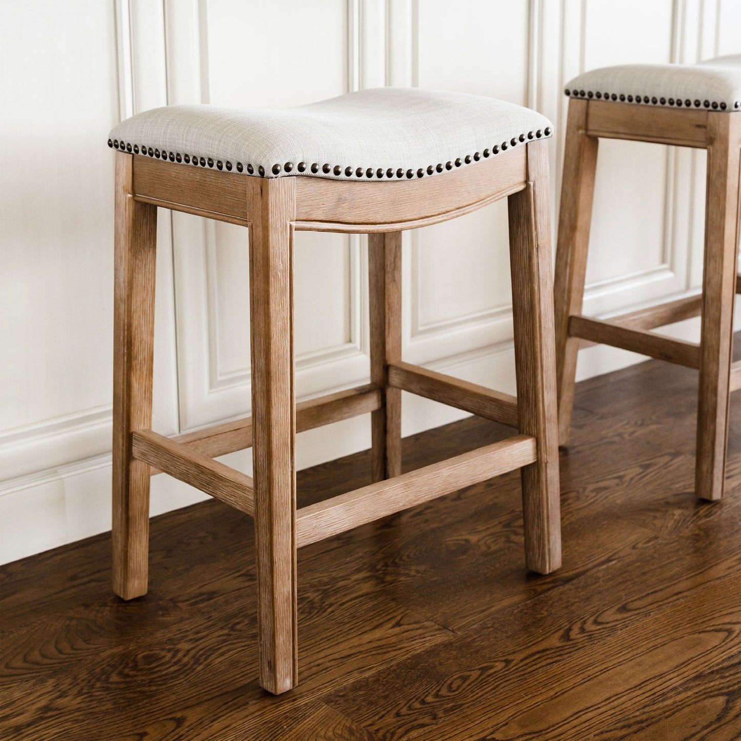 Maven Lane Adrien Saddle Bar Stool in Weathered Oak Finish w/ Sand Color Fabric Upholstery